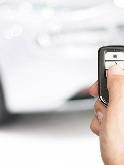 Hand of man holding and push remote control car open the door or