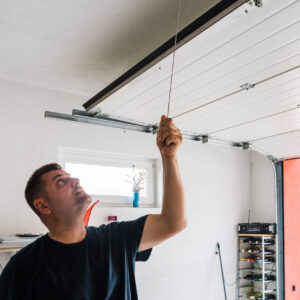 man opens pvc garage door manually man opens pvc garage door manually